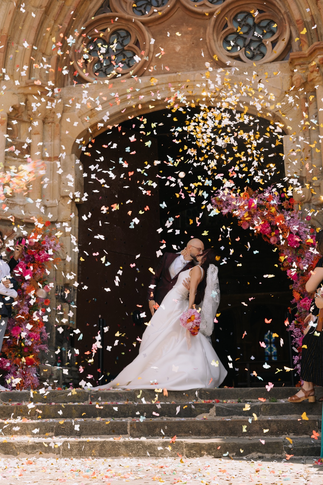 Novios a la salida De la Iglesia con los pétalos.